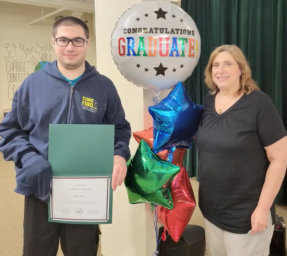 man holding diploma in his graduation day